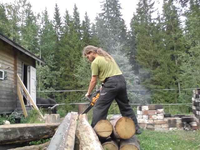 cutting leftover logs to make firewood