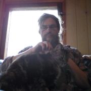 Mending my jeans. The cat wants to help.