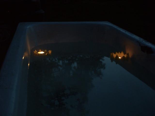 candles floating in my outdoor bathtub.