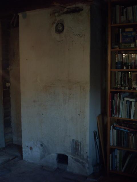 The square hole near the floor is entrance to the chimney.