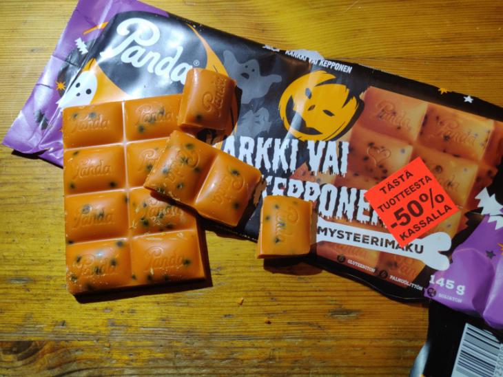 That orange substance is halloween-themed chocolate. "Mystery flavour!" says the packaging and it makes me wonder why it didn't sell that good, if they still have left-over stock to be sold for discounted prices...
